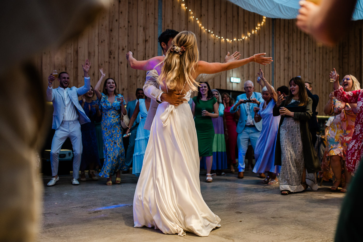 Bride and groom asking wedding guests to join in, during the first dance at The Grain Store.