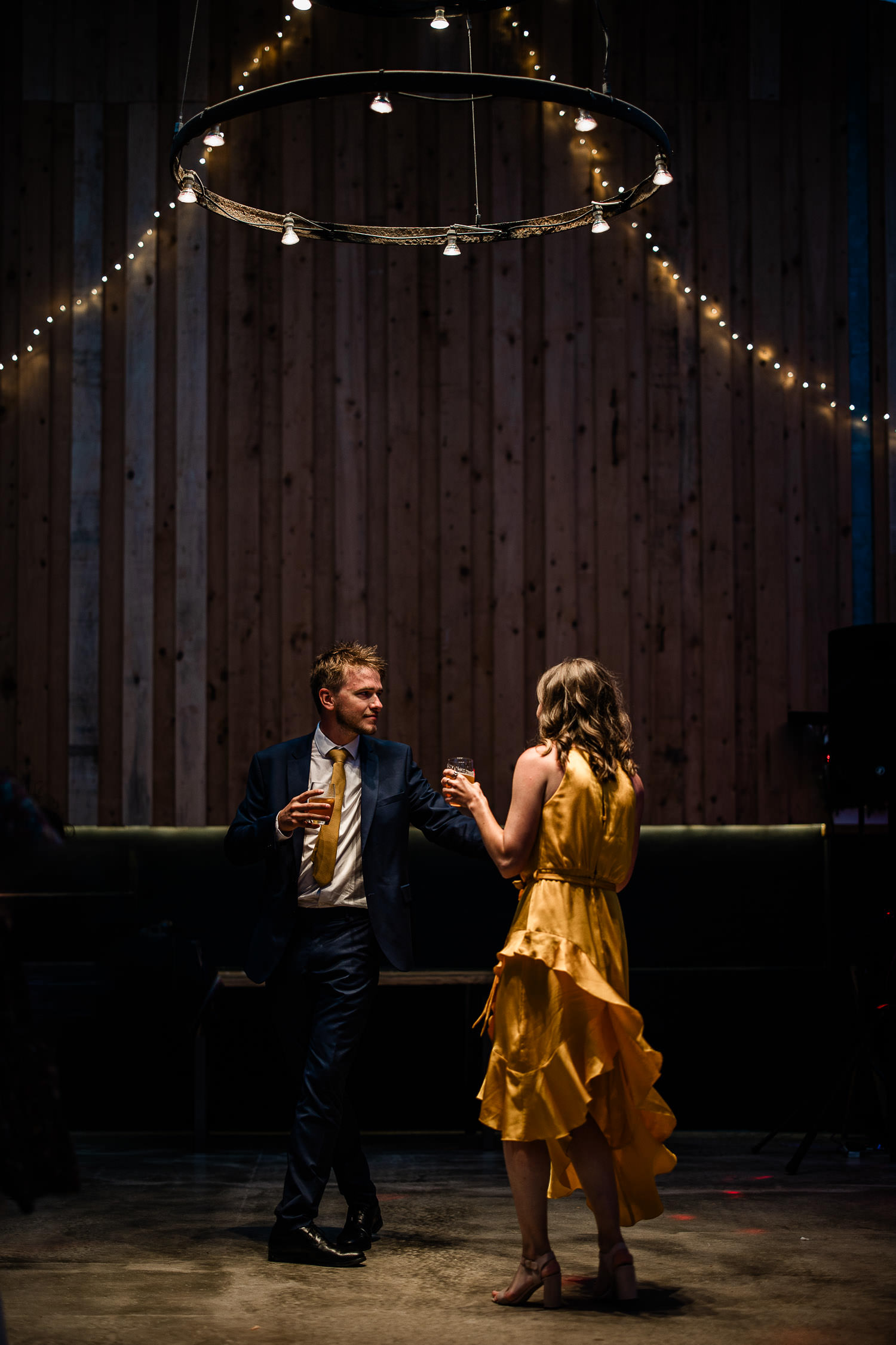 Couple dancing under fairy lights, at a barn wedding reception in Devon.